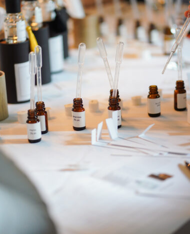 Perfumery workshop table with droppers and amber bottles of essential oils